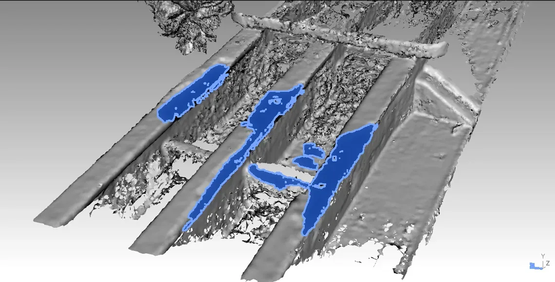 A 3D model of the girders with the damage shown in blue.