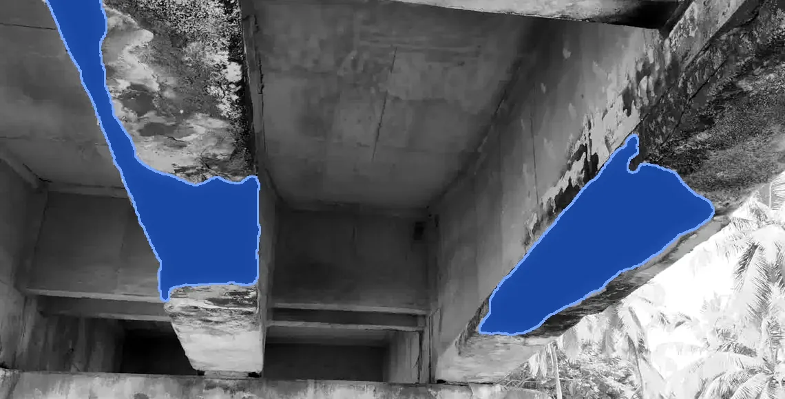 Bridge girders with spalled areas marked in blue.